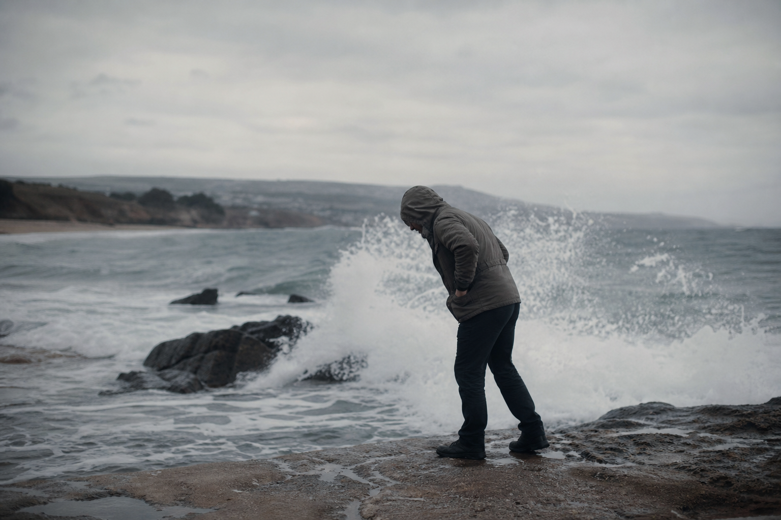 A person pushing against a strong incoming tide on a beach