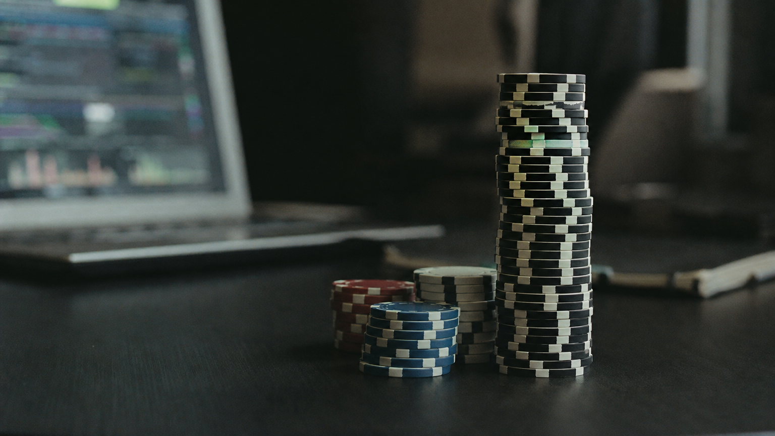 A single large chip stacked far higher than the others on a table, representing a concentrated bet